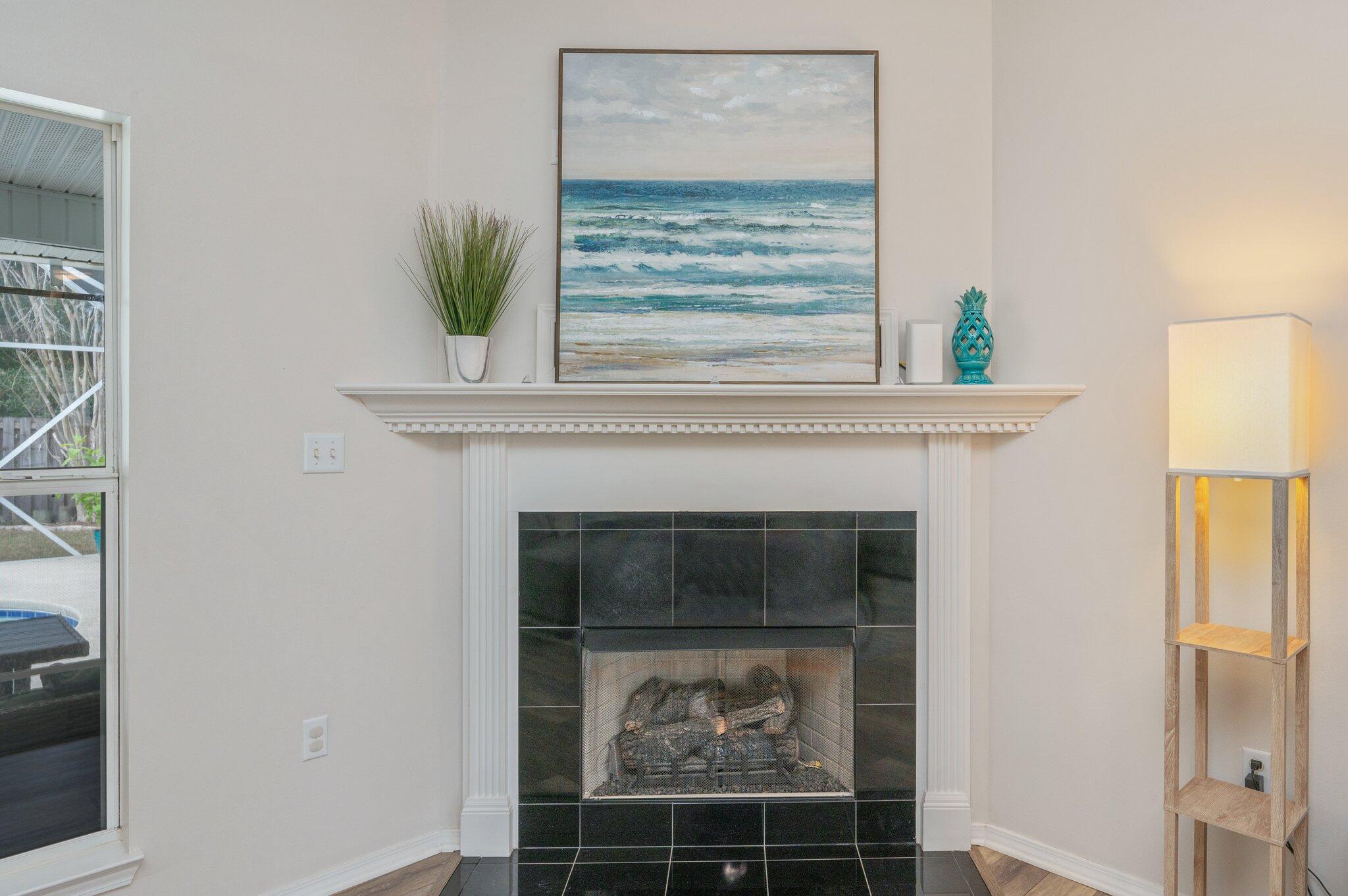 730 Denise Drive Crestview, FL 32536 - Photo 9 of 40 a living room with a fireplace and a potted plant
