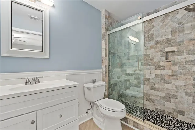 a bathroom with a sink a toilet and a shower