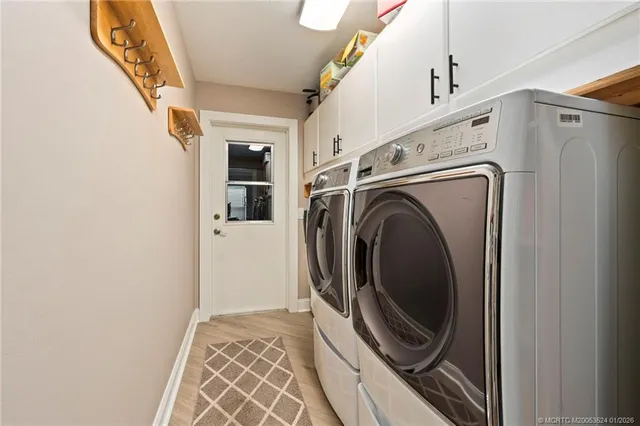 a view of a storage and utility room with washer and dryer