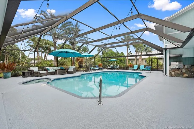 a swimming pool with outdoor seating and yard
