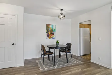 a view of a room with furniture and wooden floor