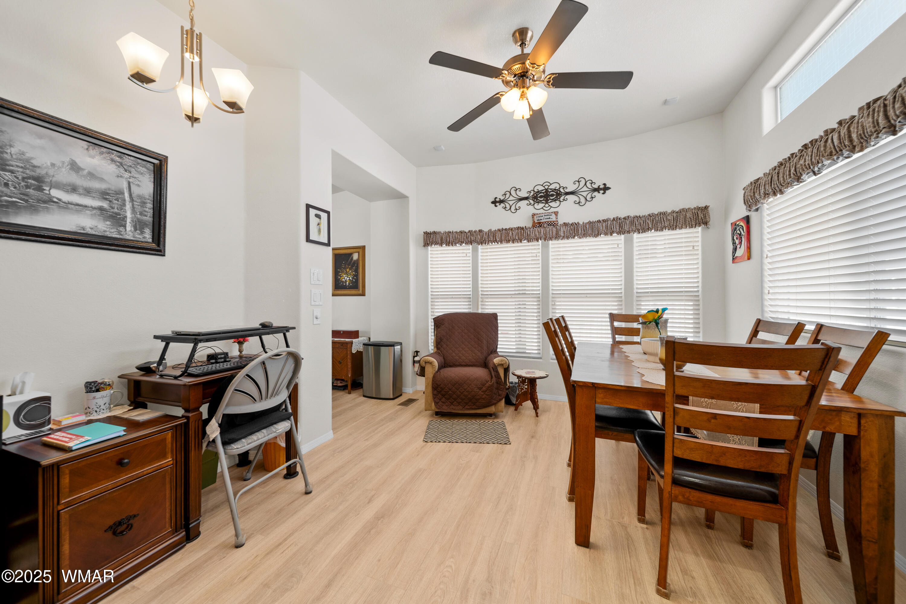 8213 Apache Way, Unit 415 Show Low, AZ 85901 - Photo 6 of 16 a view of a dining room with furniture window and wooden floor