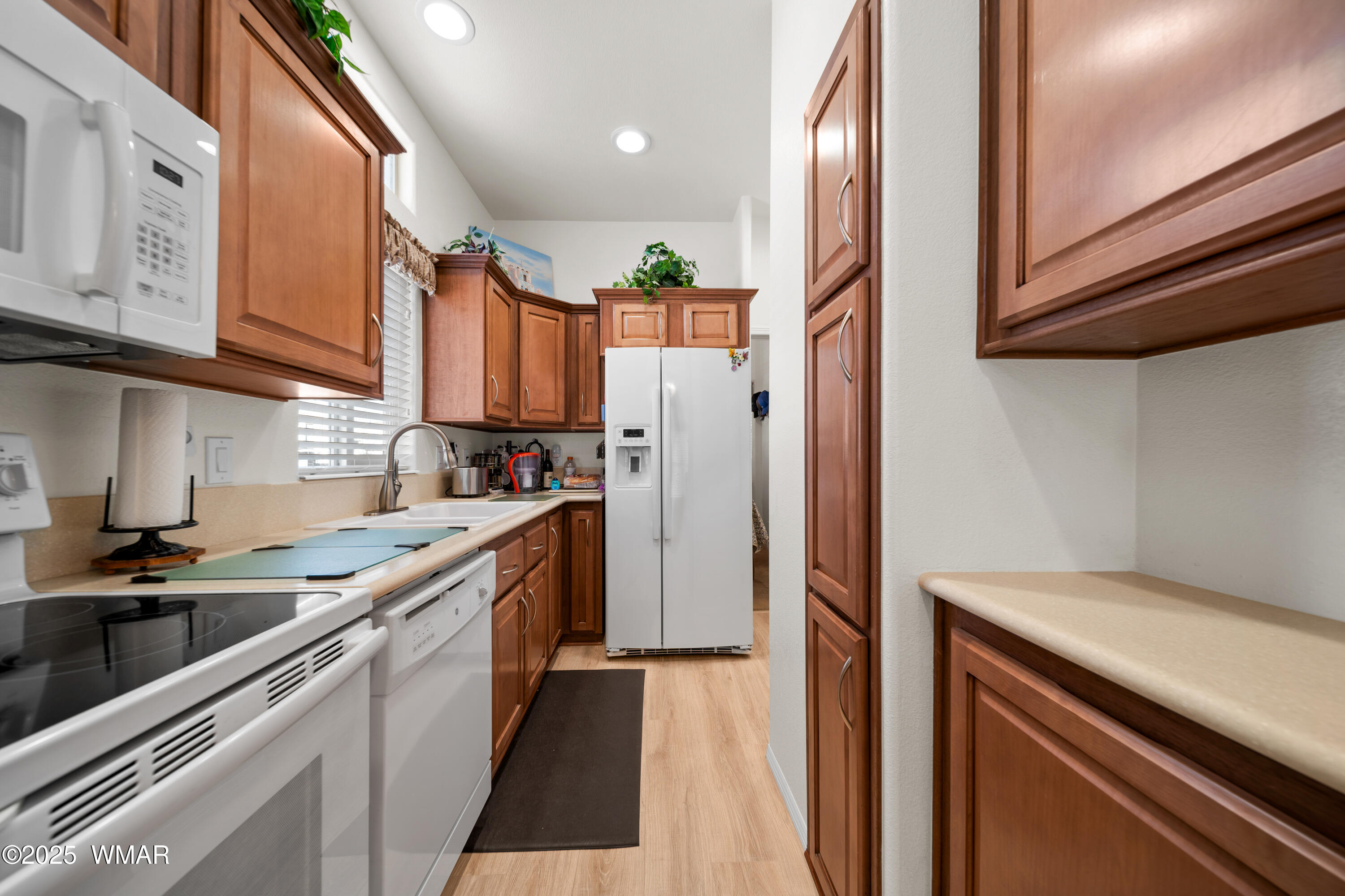 8213 Apache Way, Unit 415 Show Low, AZ 85901 - Photo 8 of 16 a kitchen with stainless steel appliances granite countertop a refrigerator and a sink