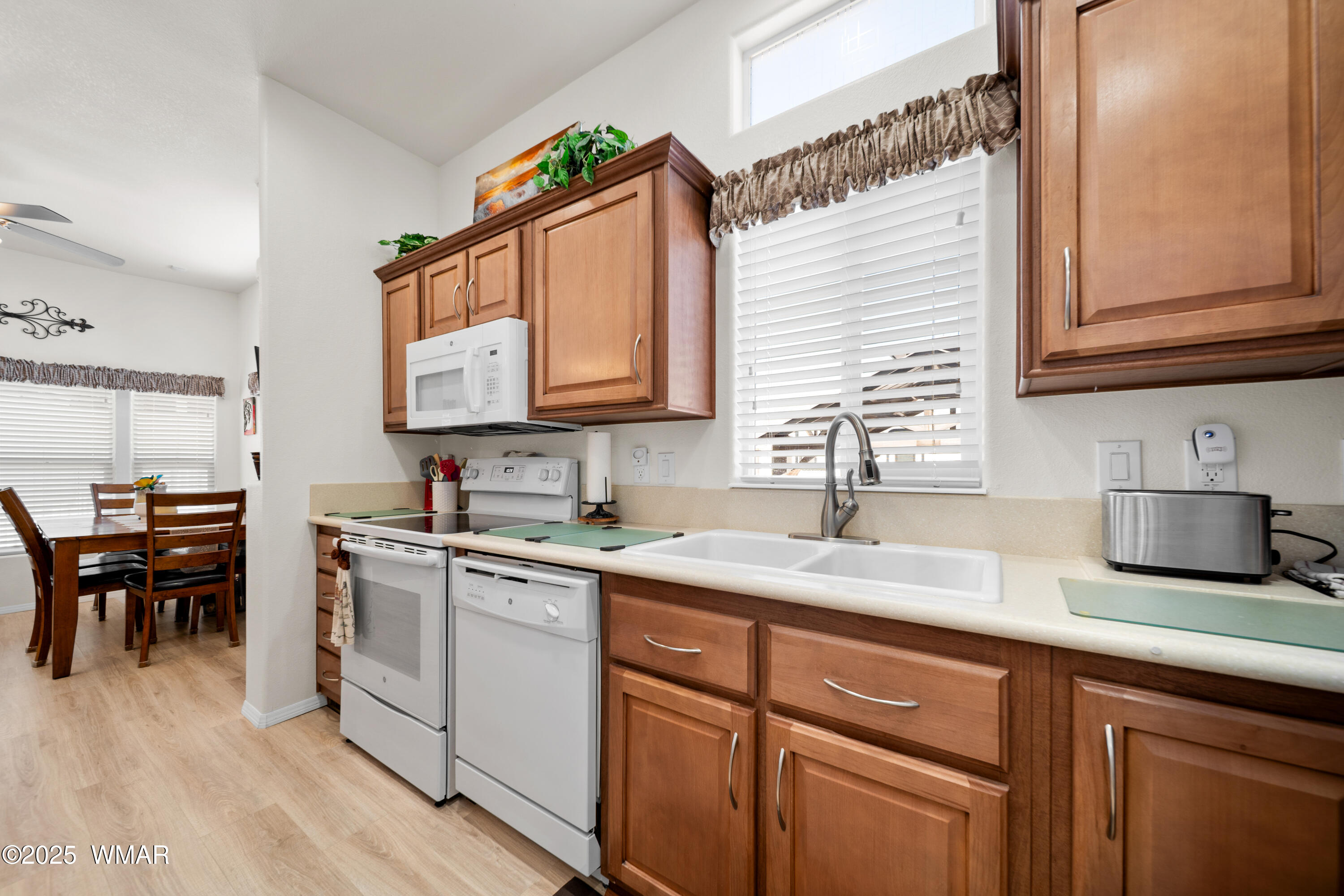 8213 Apache Way, Unit 415 Show Low, AZ 85901 - Photo 9 of 16 a kitchen with a sink cabinets and window