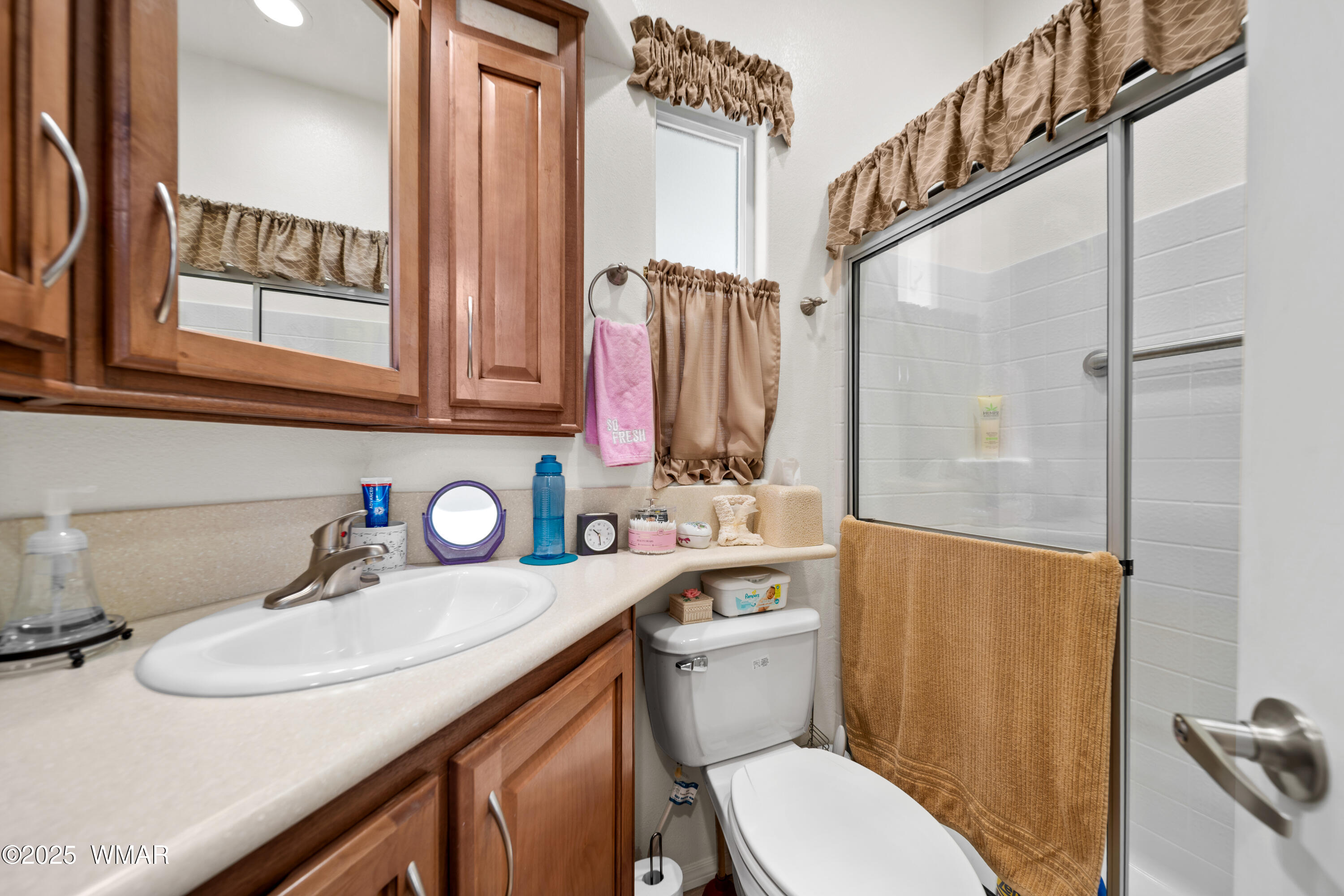 8213 Apache Way, Unit 415 Show Low, AZ 85901 - Photo 10 of 16 a bathroom with a sink toilet and shower