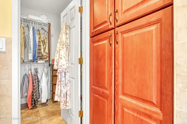 a view of a house with a yard and large tree