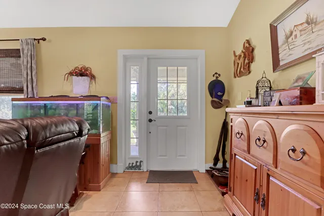 a living room with furniture ceiling fan and a rug