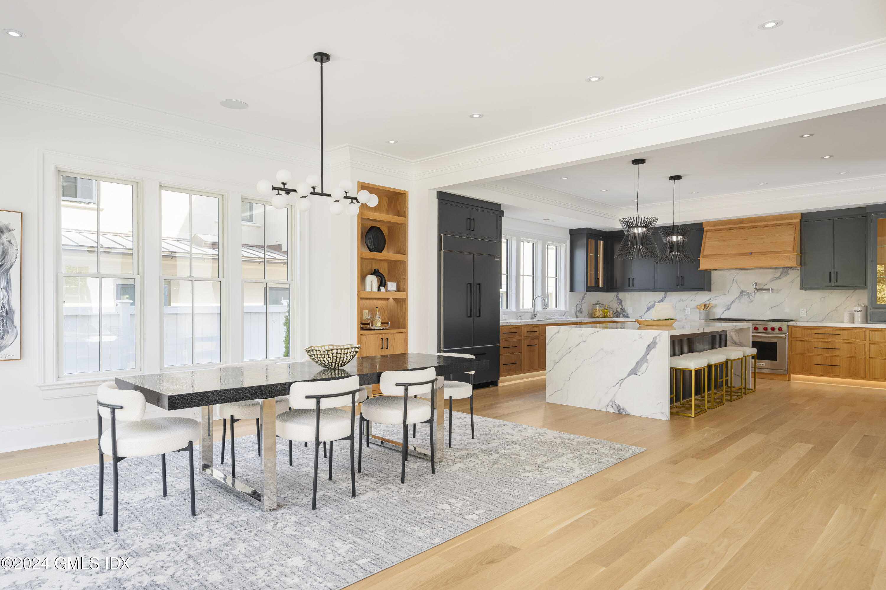 66 Ridge Street Greenwich, CT 06830 - Photo 14 of 40 a living room with furniture a large window and a dining table