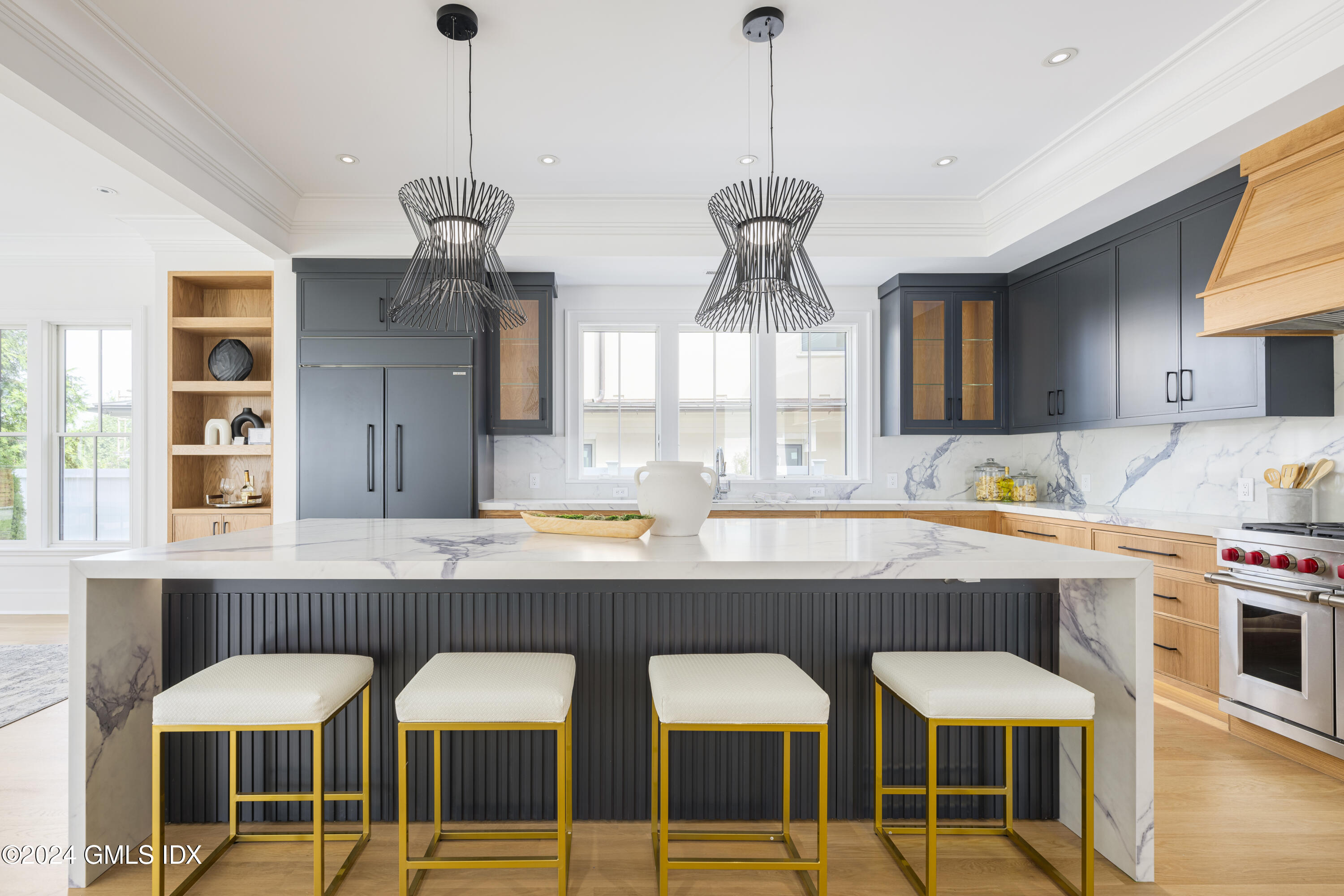 66 Ridge Street Greenwich, CT 06830 - Photo 16 of 40 a kitchen with a dining table chairs and white cabinets