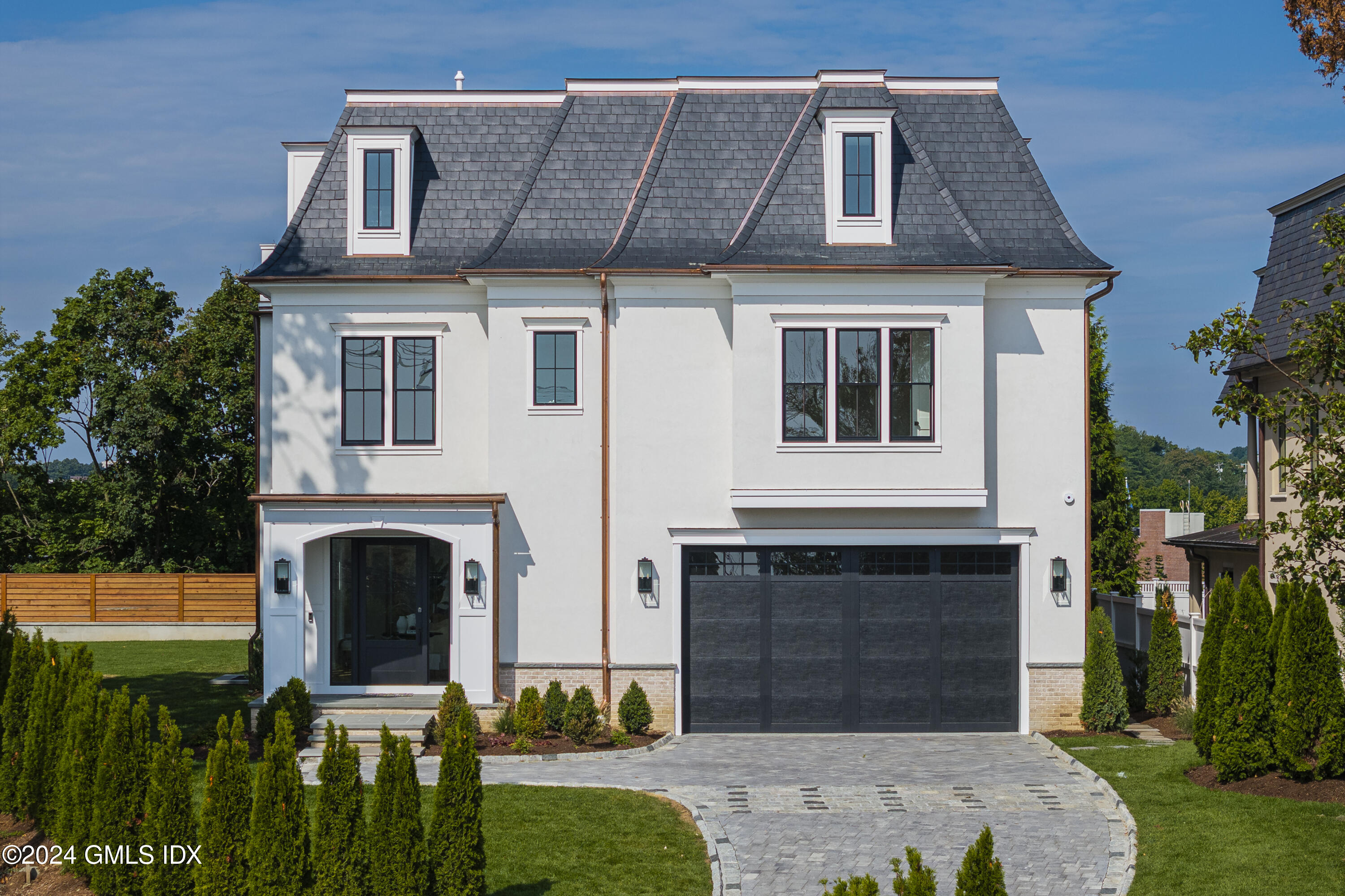 66 Ridge Street Greenwich, CT 06830 - Photo 2 of 40 a front view of a house with a yard