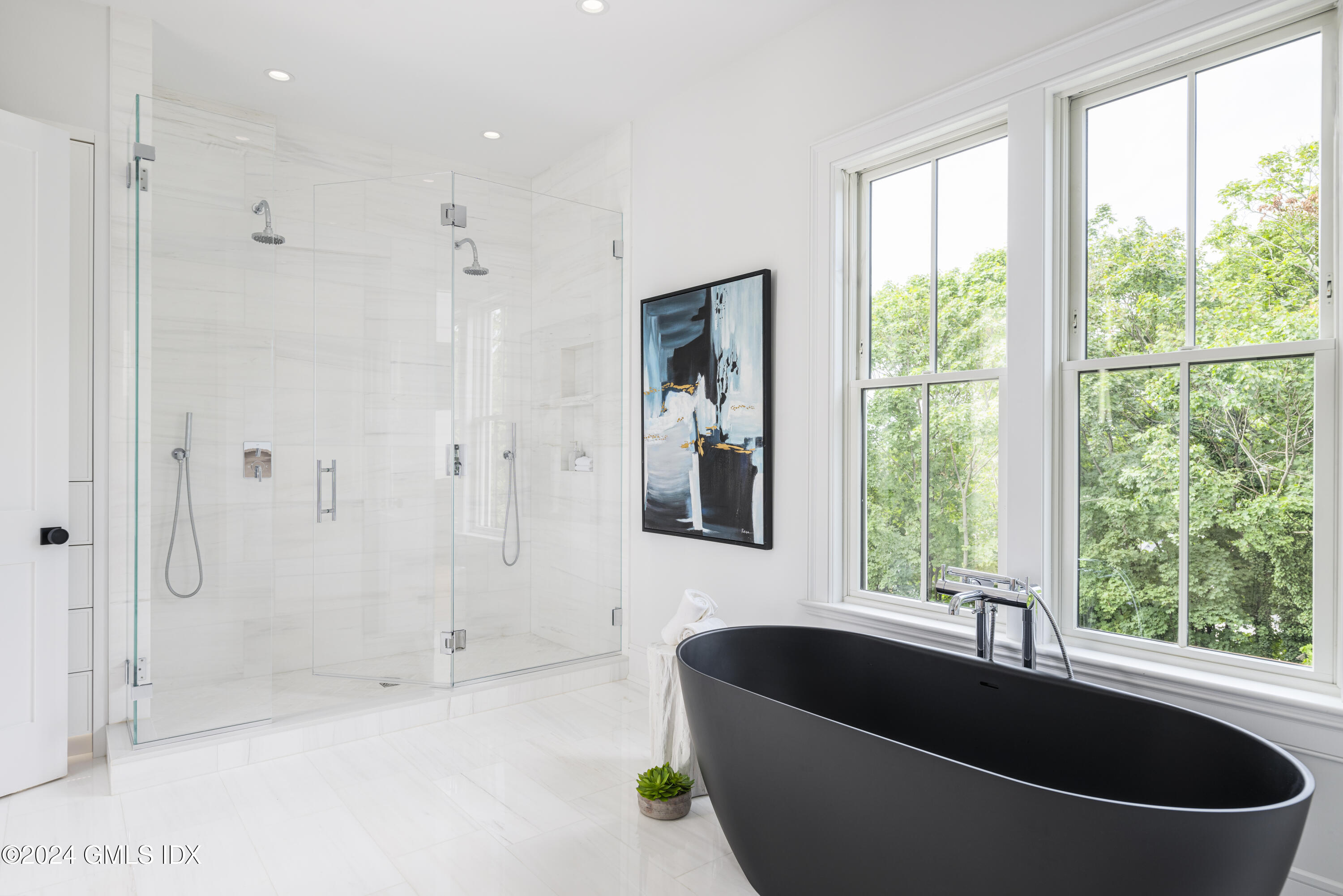 66 Ridge Street Greenwich, CT 06830 - Photo 23 of 40 a bath tub sitting in a bathroom next to a window