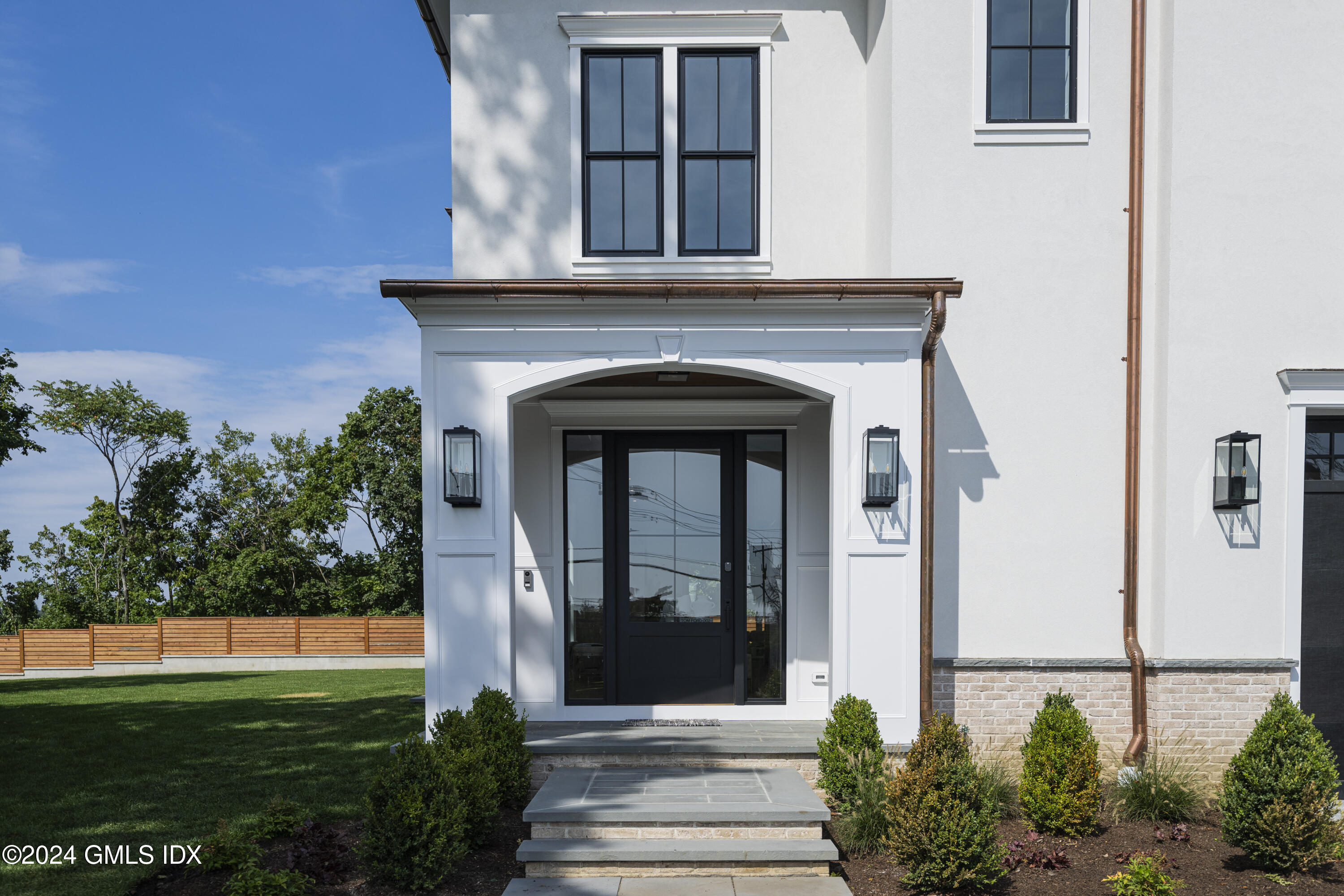 66 Ridge Street Greenwich, CT 06830 - Photo 4 of 40 a front view of a house with a garden