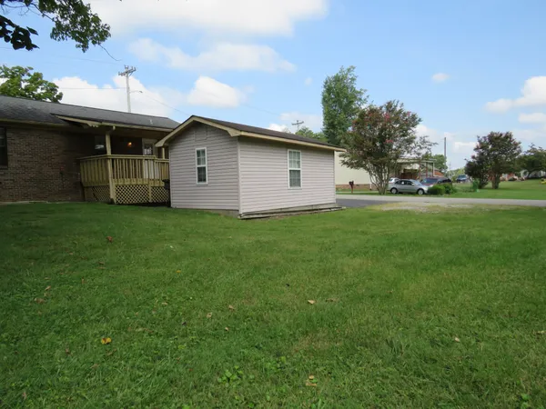 a front view of house with yard and trees