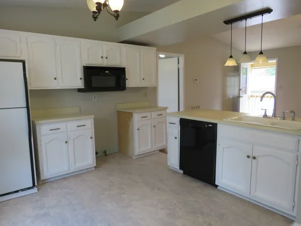 a kitchen with white cabinets and a sink