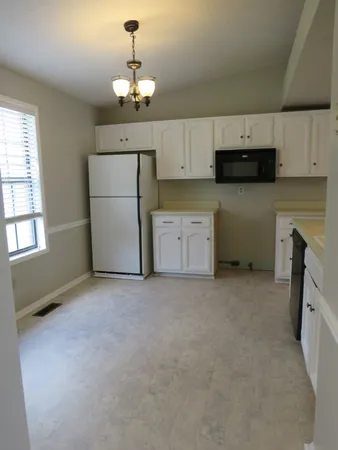 a view of a kitchen with a sink dishwasher and a refrigerator
