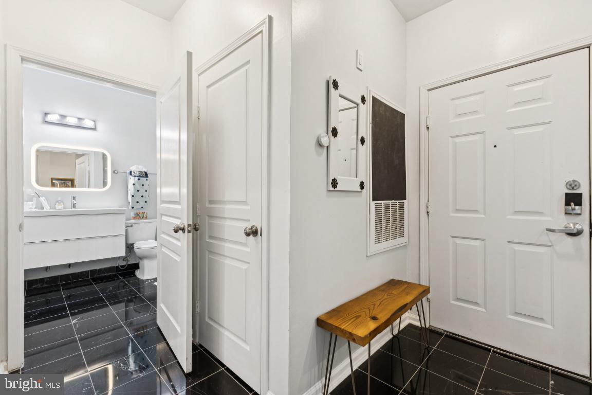 12000 Market Street, Unit 151 Reston, VA 20190 - Photo 21 of 58 Foyer with kitchen to left and bath to right