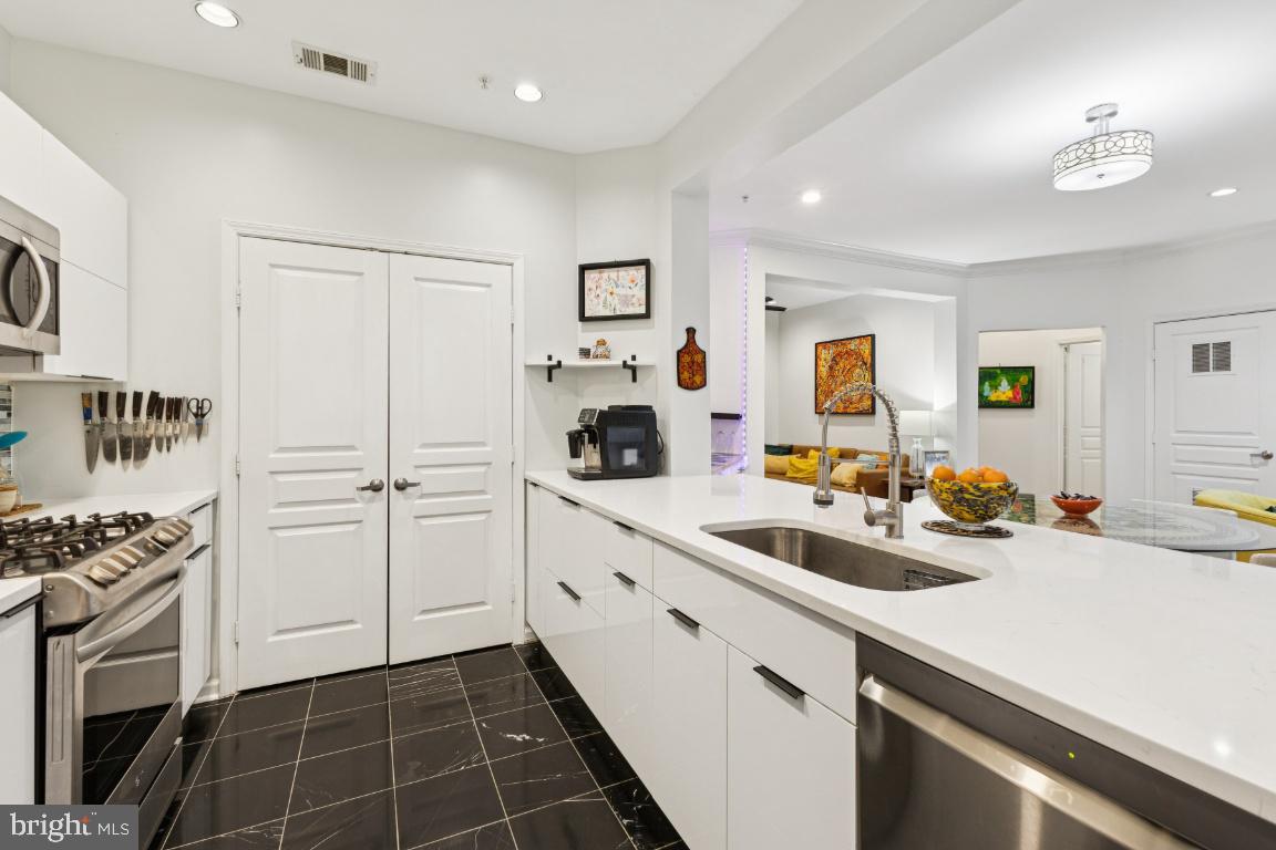 12000 Market Street, Unit 151 Reston, VA 20190 - Photo 6 of 58 Kitchen with marble tiles & high-end cabinetry