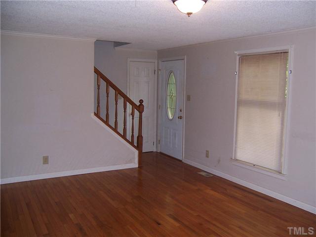 350 Wrenn Crumpton Road Roxboro, NC 27574 - Photo 5 of 12 Living area has hardwood flooring and staircase to upper level