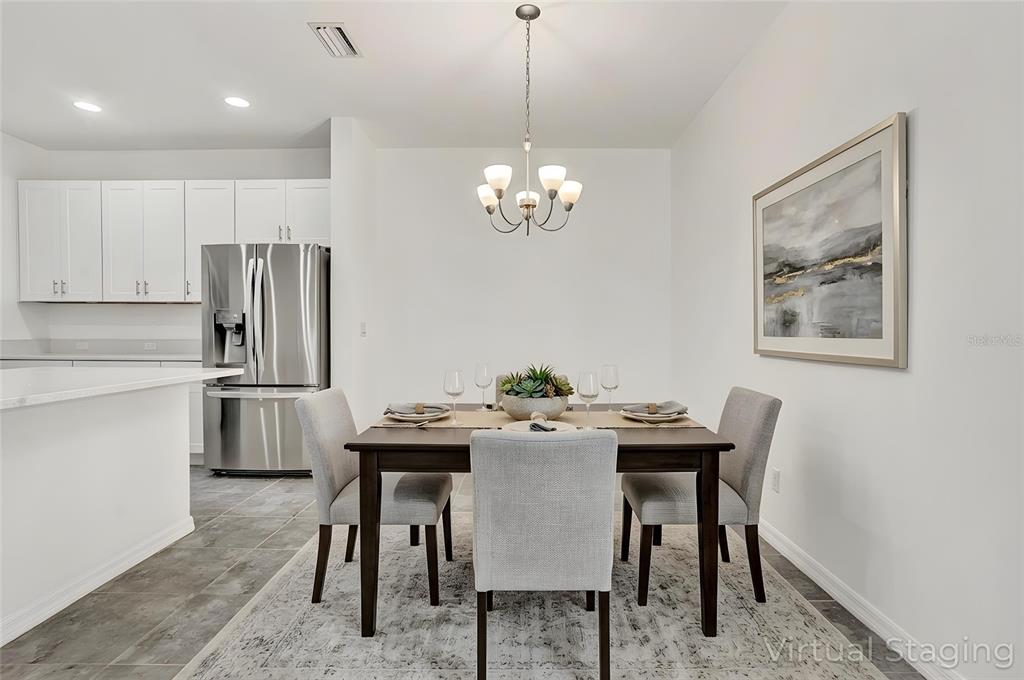 8544 Cache Drive Sarasota, FL 34240 - Photo 11 of 46 a view of a dining room with furniture and a chandelier