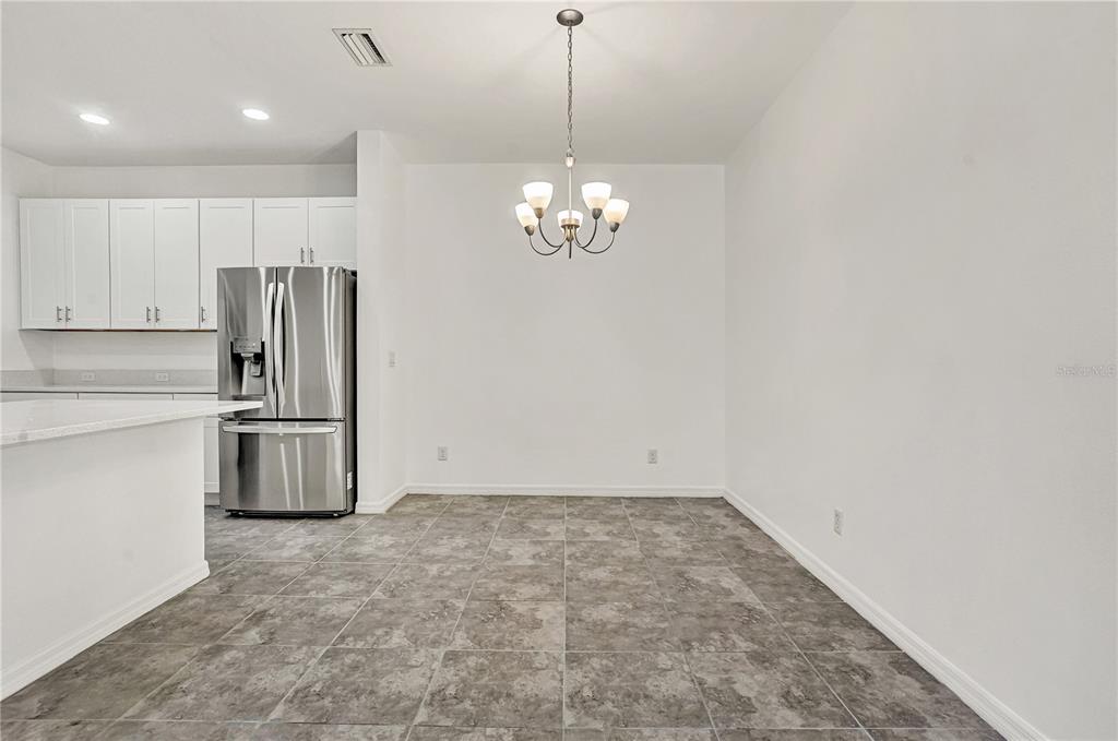 8544 Cache Drive Sarasota, FL 34240 - Photo 12 of 46 a kitchen with stainless steel appliances a refrigerator and a stove top oven