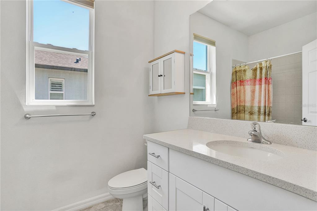 8544 Cache Drive Sarasota, FL 34240 - Photo 25 of 46 a bathroom with a sink toilet vanity and window