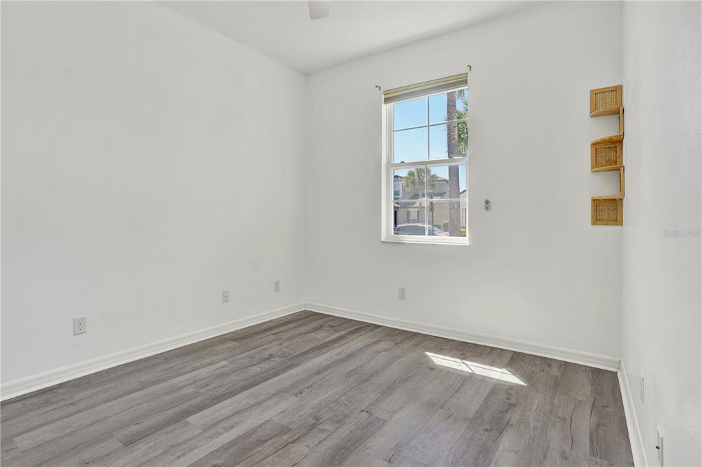 8544 Cache Drive Sarasota, FL 34240 - Photo 27 of 46 an empty room with wooden floor and windows
