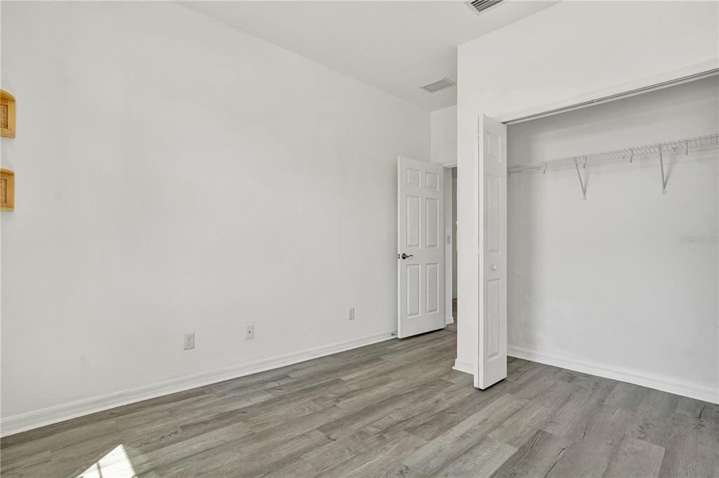 8544 Cache Drive Sarasota, FL 34240 - Photo 28 of 46 a view of an empty room with wooden floor