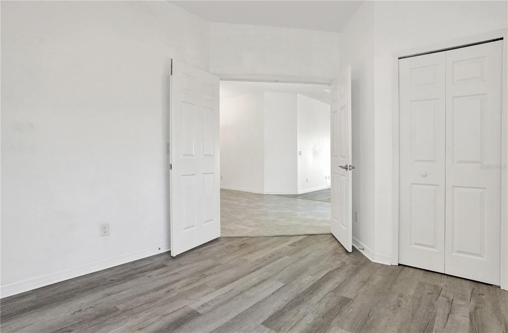 8544 Cache Drive Sarasota, FL 34240 - Photo 30 of 46 an empty room with wooden floor