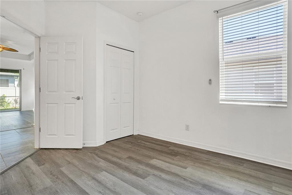 8544 Cache Drive Sarasota, FL 34240 - Photo 31 of 46 an empty room with wooden floor and windows