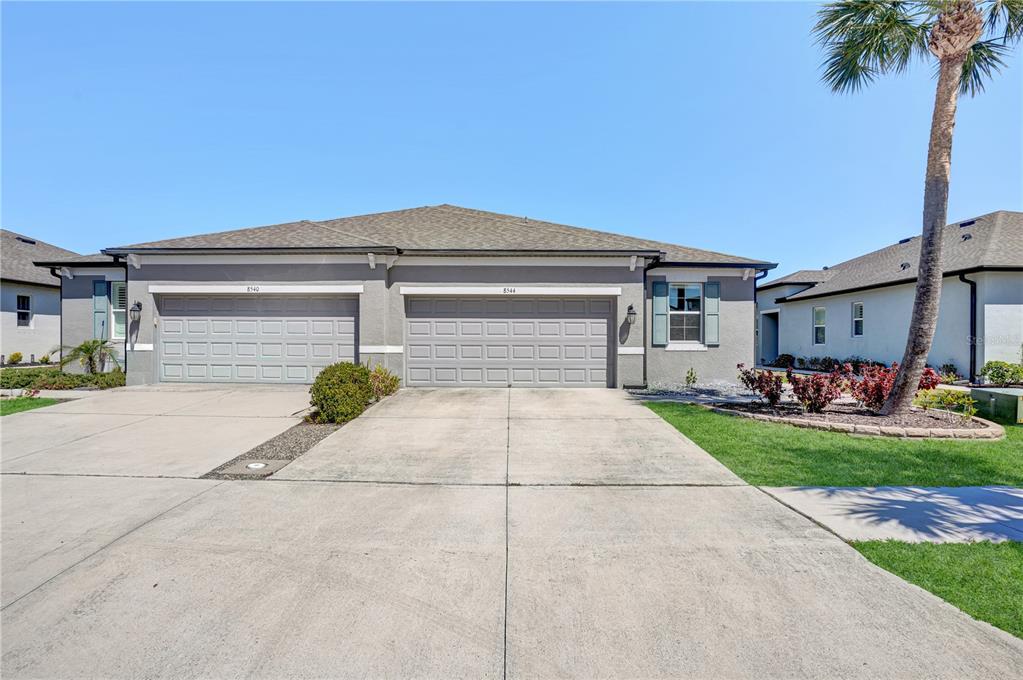 8544 Cache Drive Sarasota, FL 34240 - Photo 38 of 46 a house with a yard and a garage