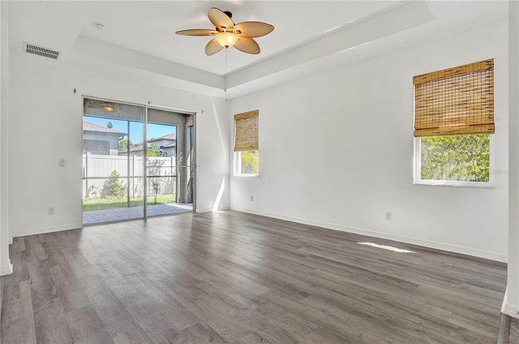 8544 Cache Drive Sarasota, FL 34240 - Photo 4 of 46 a view of an empty room with a window and wooden floor