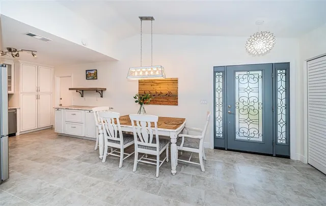 a dining room with furniture and window
