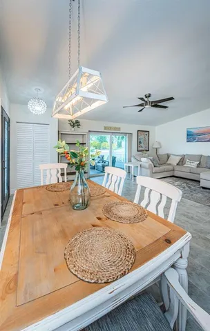 a living room with furniture a flat screen tv and kitchen view