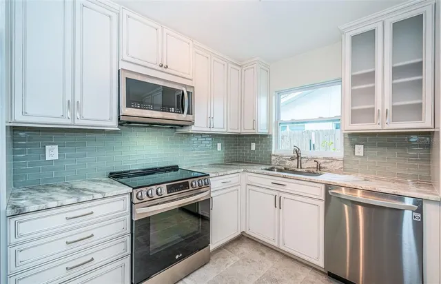 a view with table chairs and refrigerator in kitchen