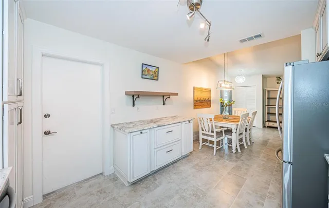 a kitchen with stainless steel appliances granite countertop a refrigerator stove and sink