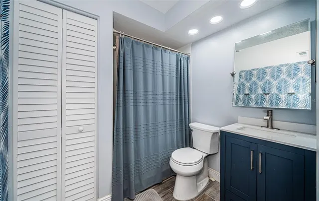 a view of a room with wooden floor and windows