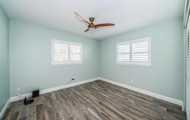 wooden floor in an empty room with a window