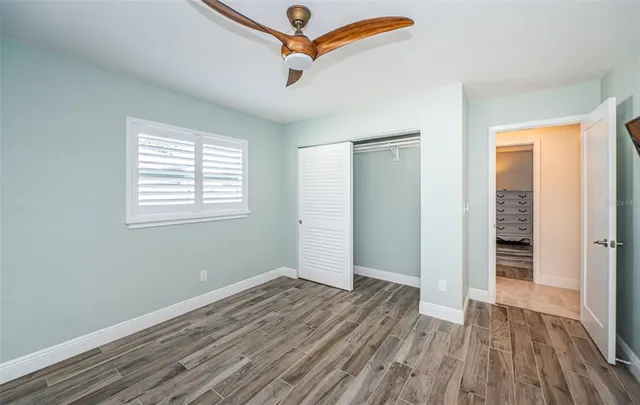 a bathroom with a double vanity sink toilet mirror and bathtub