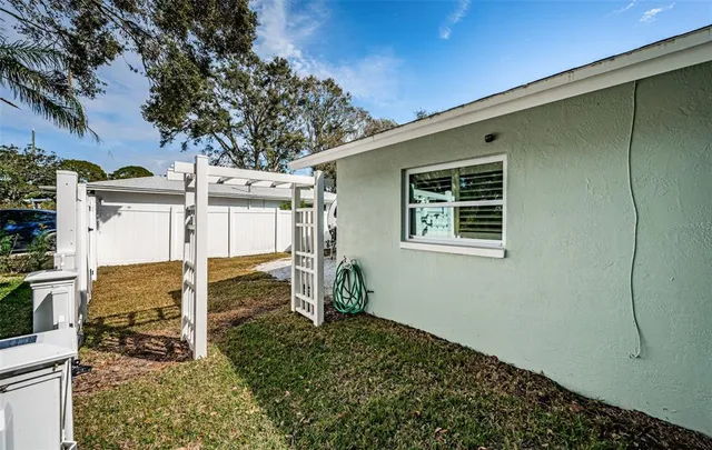 a backyard of a house with table and chairs