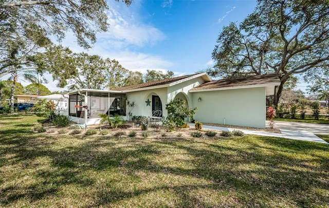 a view of a house with backyard and sitting area