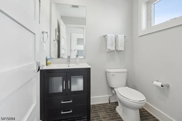 a bathroom with a sink a toilet and mirror