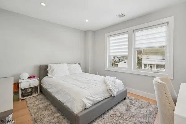 a bedroom with a bed and a large window