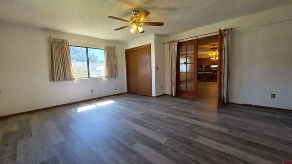 an empty room with wooden floor and a window
