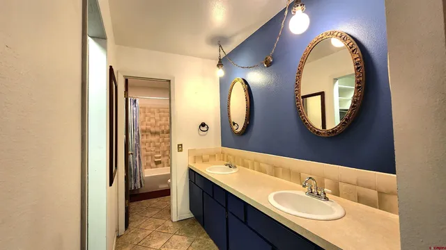 a bathroom with a double vanity sink and a mirror
