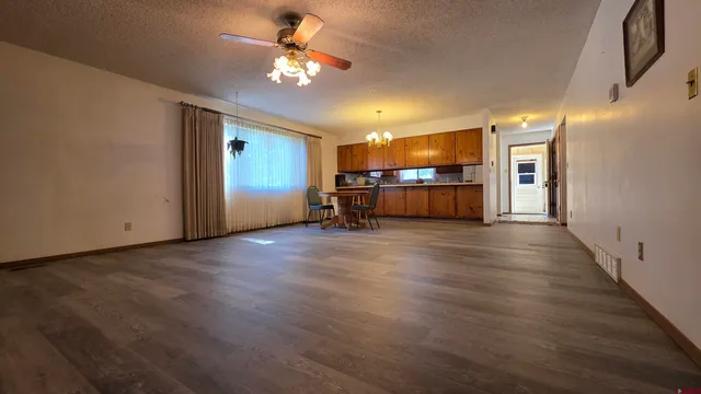 a view of a livingroom with furniture wooden floor and chandelier
