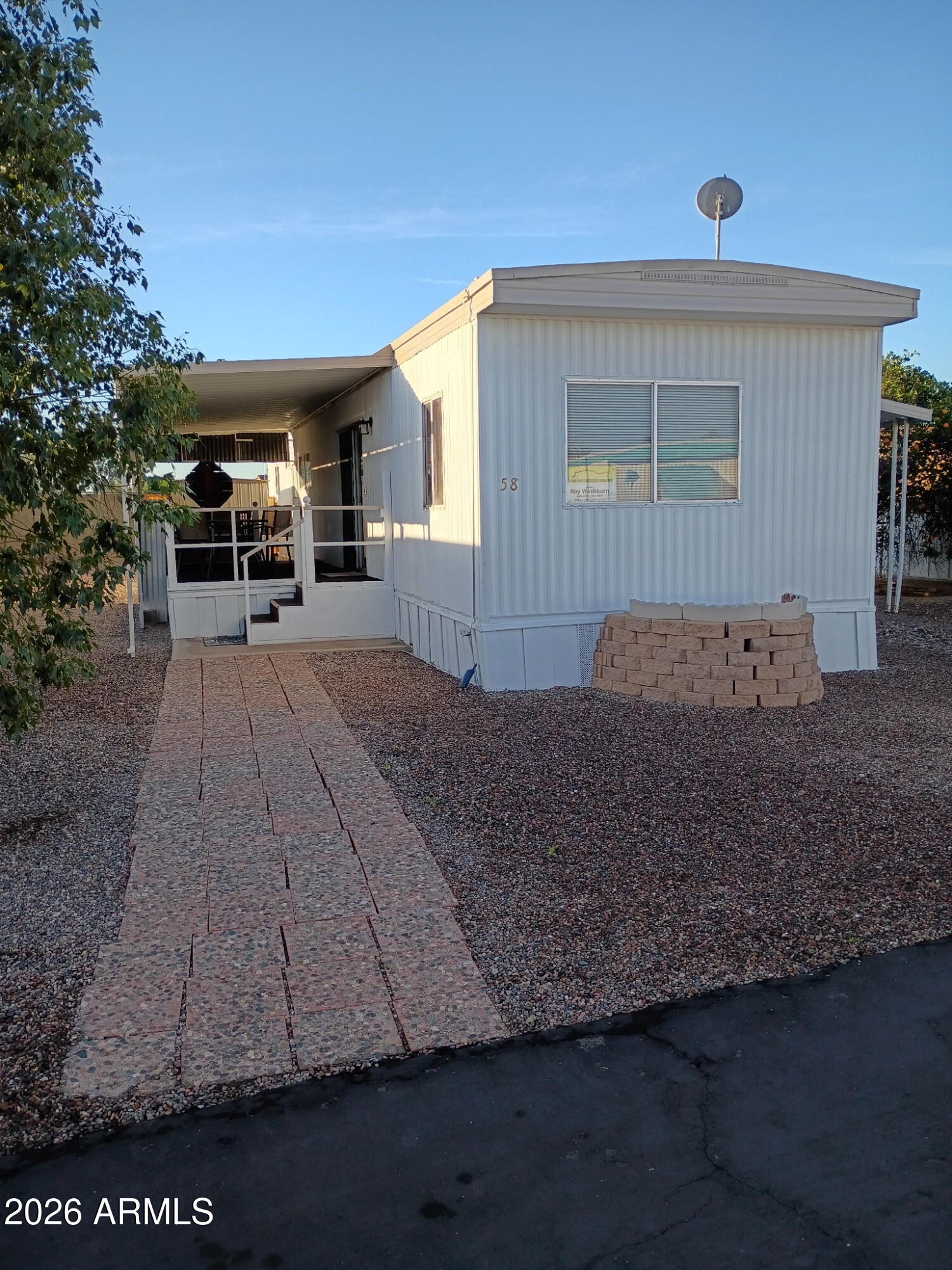 a view of a house with backyard porch and sitting area