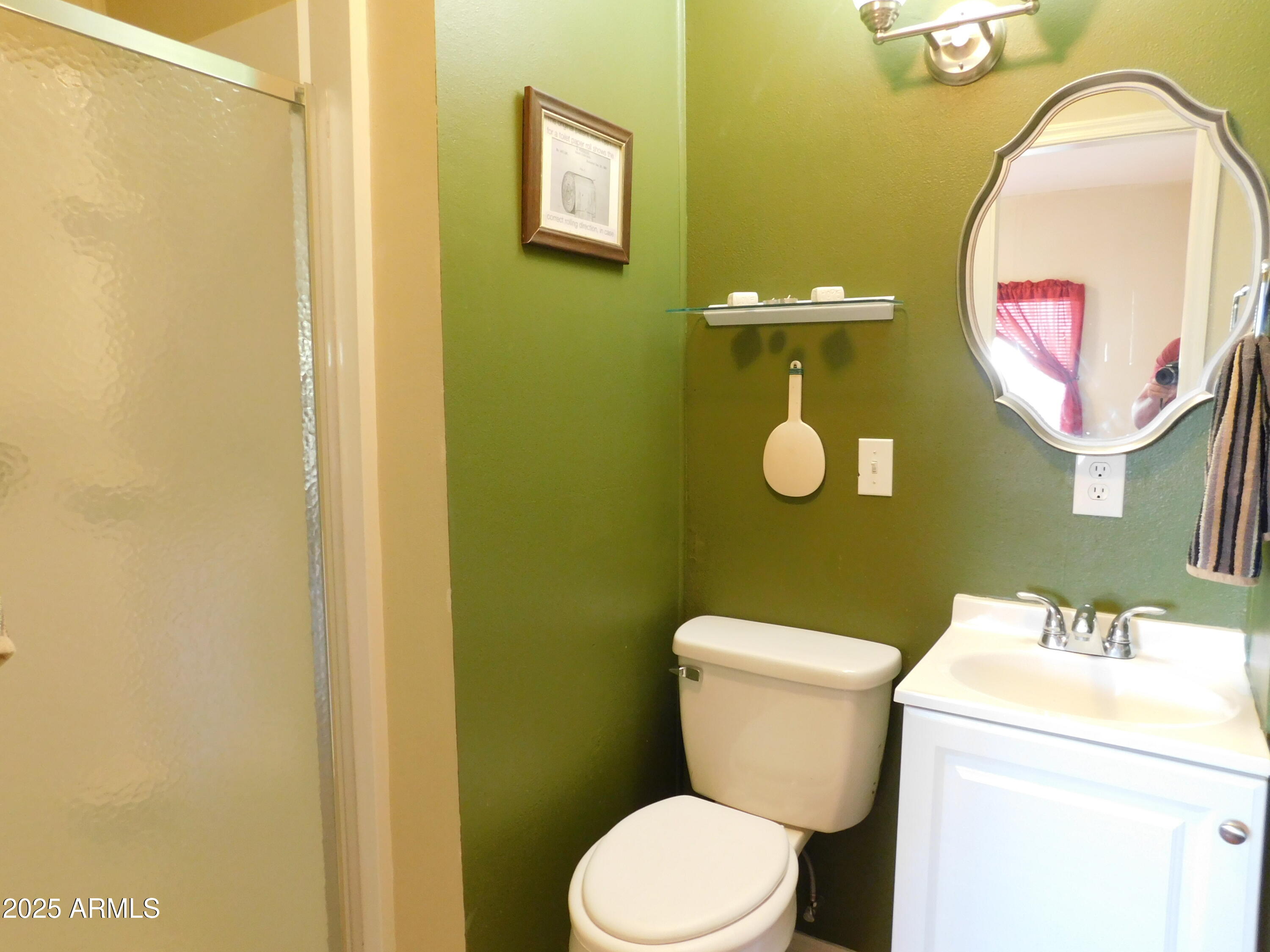 15802 South Gilbert Road, Unit 58 Chandler, AZ 85225 - Photo 11 of 21 a bathroom with a toilet sink vanity and mirror