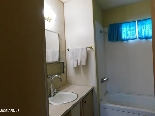 a view of a house with backyard space and sitting area