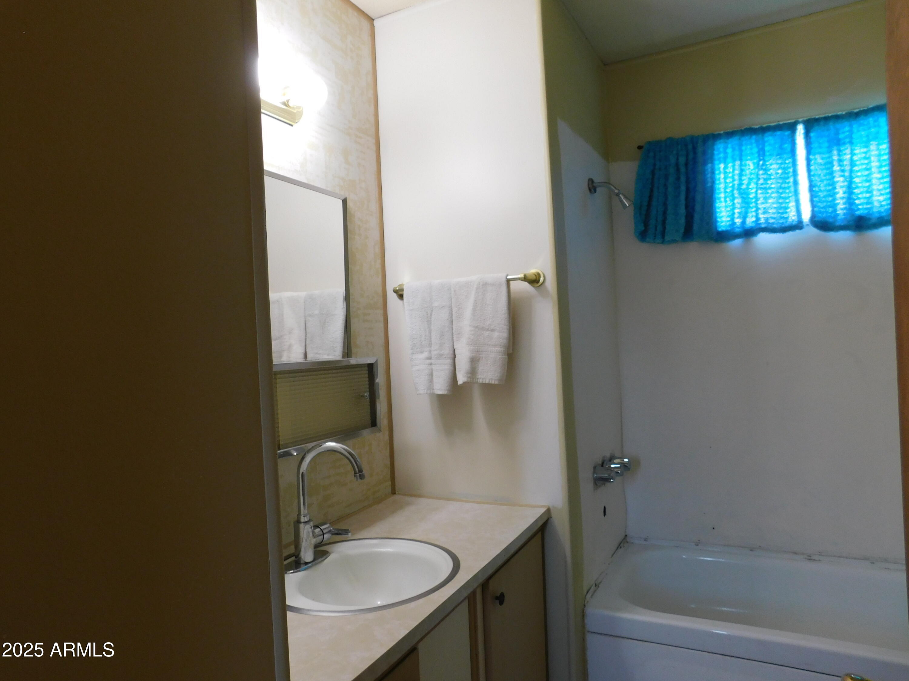 15802 South Gilbert Road, Unit 58 Chandler, AZ 85225 - Photo 15 of 21 a bathroom with a sink and a mirror
