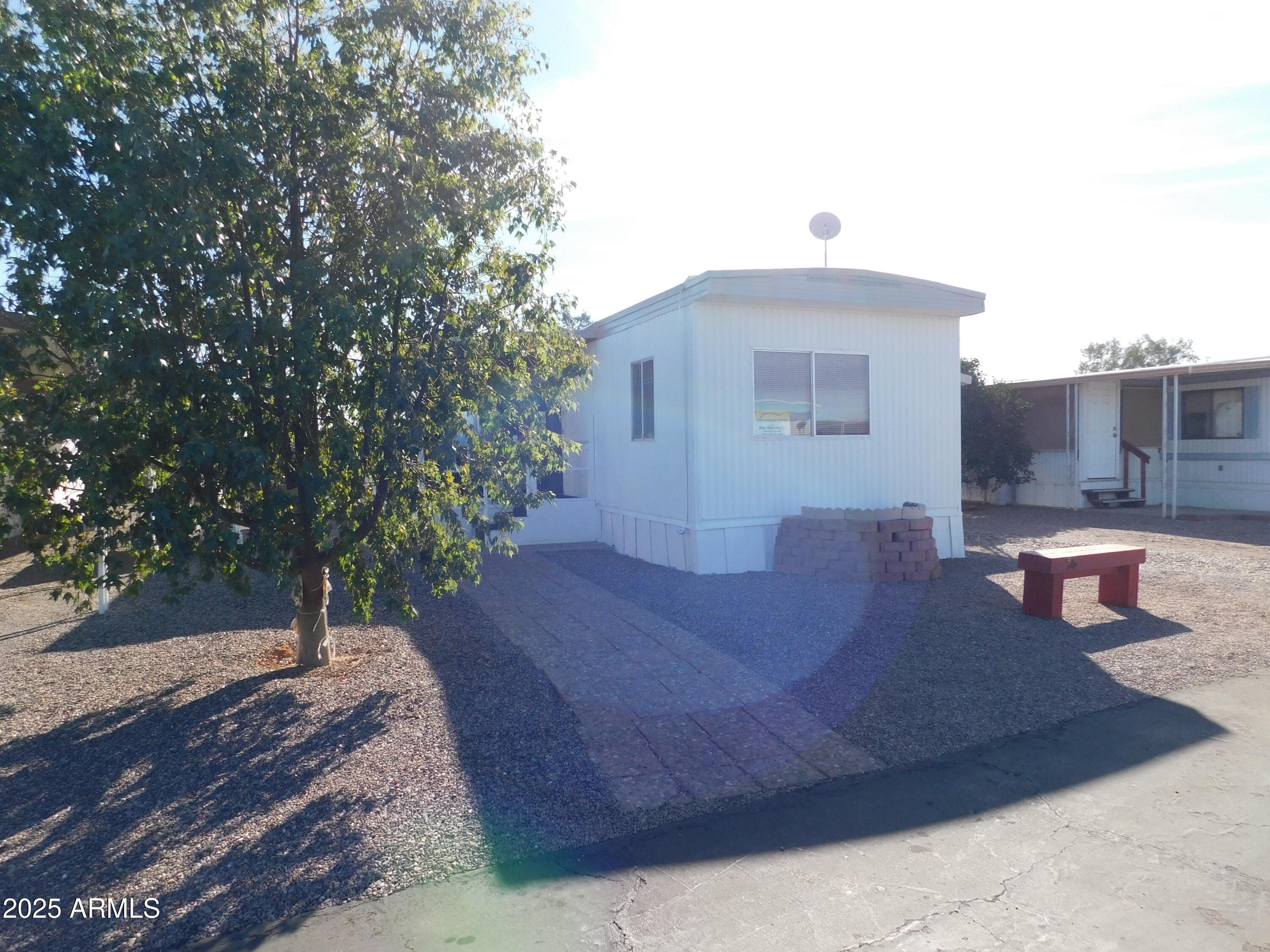 15802 South Gilbert Road, Unit 58 Chandler, AZ 85225 - Photo 2 of 21 a front view of a house with a yard